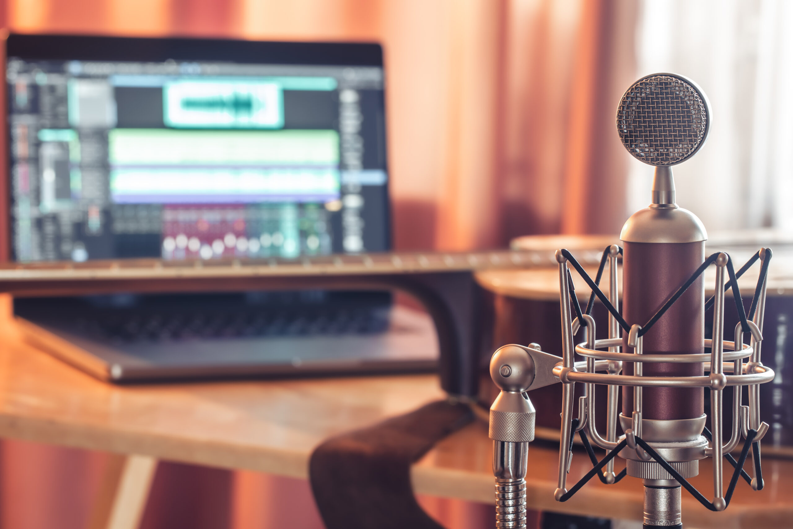 Professional microphone on blurred background, sound recording concept.